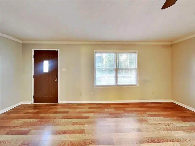 a view of a livingroom with wooden floor and window