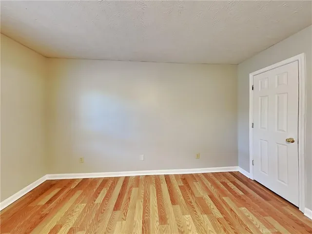 a view of an empty room and wooden floor