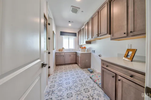 a kitchen with granite countertop a sink stainless steel appliances and cabinets