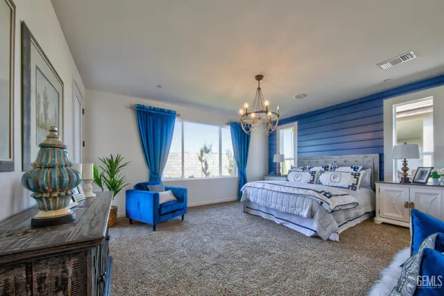 a spacious bedroom with a bed dresser and a window