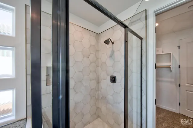 a bathroom with a shower and a sink