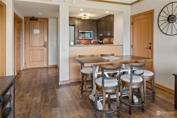 a dining room with furniture and wooden floor