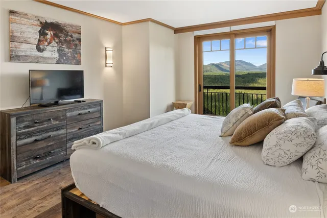 a bedroom with a bed and a flat screen tv