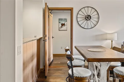 a dining room with furniture and a mirror