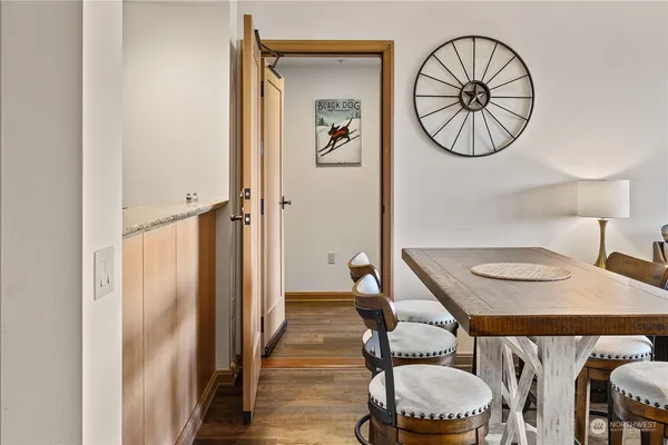 a dining room with furniture and a mirror