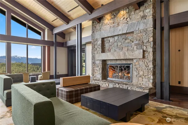 a living room with furniture a large window and a fireplace