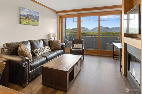 a living room with furniture and a floor to ceiling window
