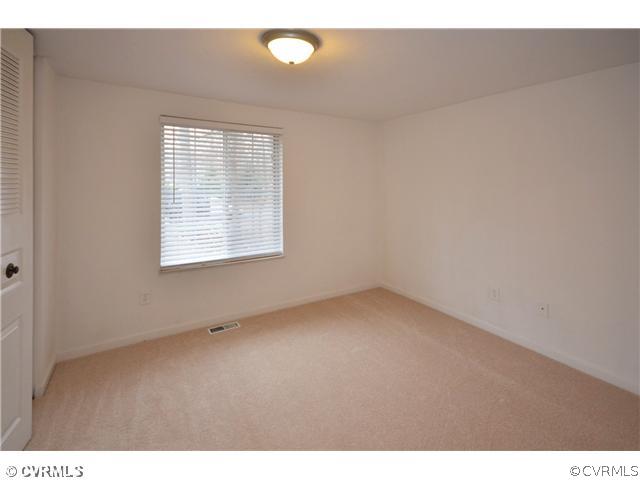 13810 Sutters Mill Road Midlothian, VA 23112 - Photo 5 of 12 a view of an empty room with a window