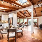 a dining hall with stainless steel appliances a dining table and chairs with wooden floor