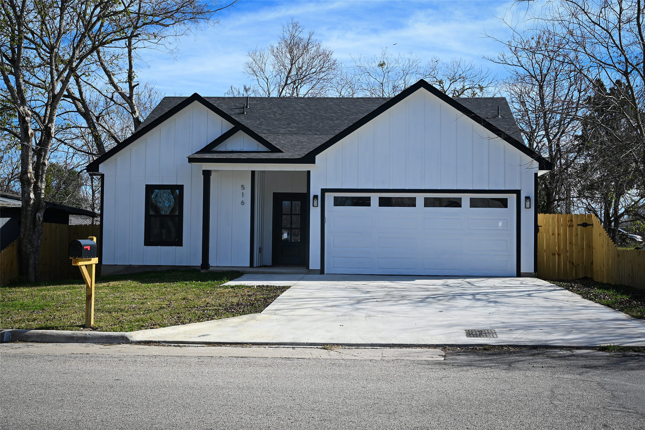 516 North Hackberry Avenue Luling, TX 78648 - Photo 30 of 36 Modern inspired farmhouse with board and batten siding, driveway, roof with shingles, and an attached garage