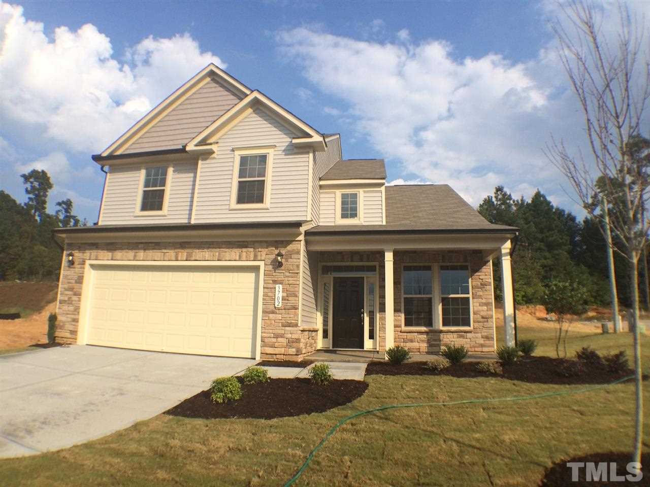 2712 Shepherd Valley Street Raleigh, NC 27610 - Photo 2 of 21 a front view of a house with a yard and garage
