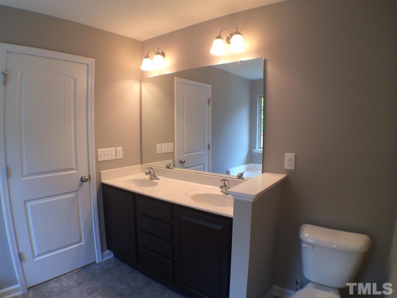 2712 Shepherd Valley Street Raleigh, NC 27610 - Photo 16 of 21 a bathroom with a toilet sink and mirror