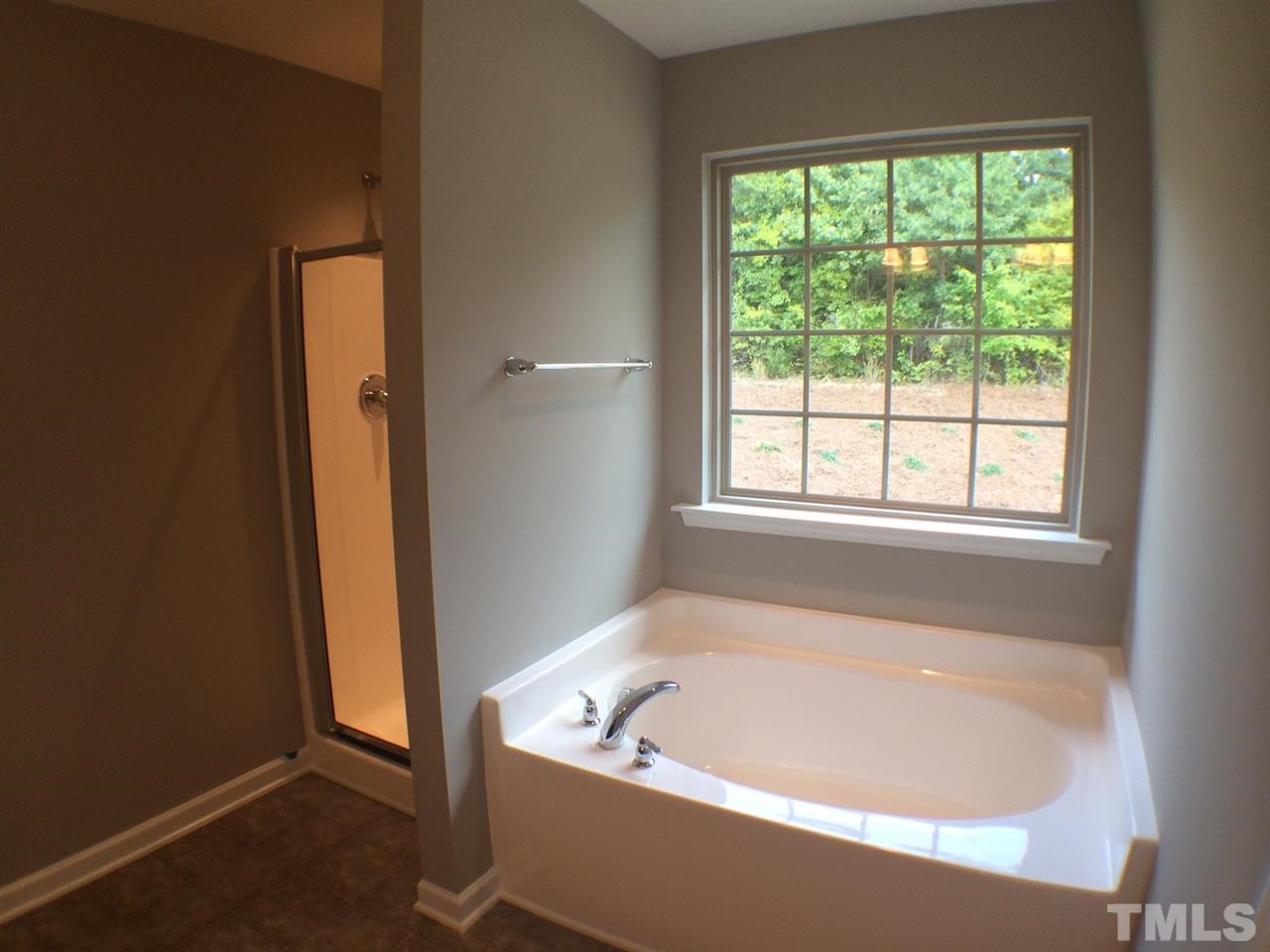 2712 Shepherd Valley Street Raleigh, NC 27610 - Photo 17 of 21 a bath tub sitting next to a window