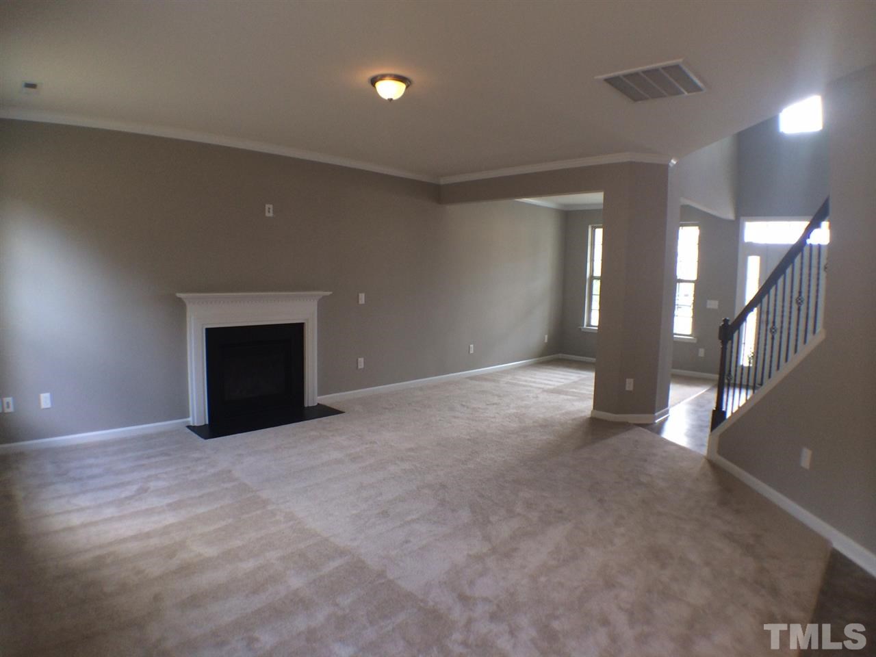 2712 Shepherd Valley Street Raleigh, NC 27610 - Photo 6 of 21 a view of an empty room with wooden floor and a fireplace