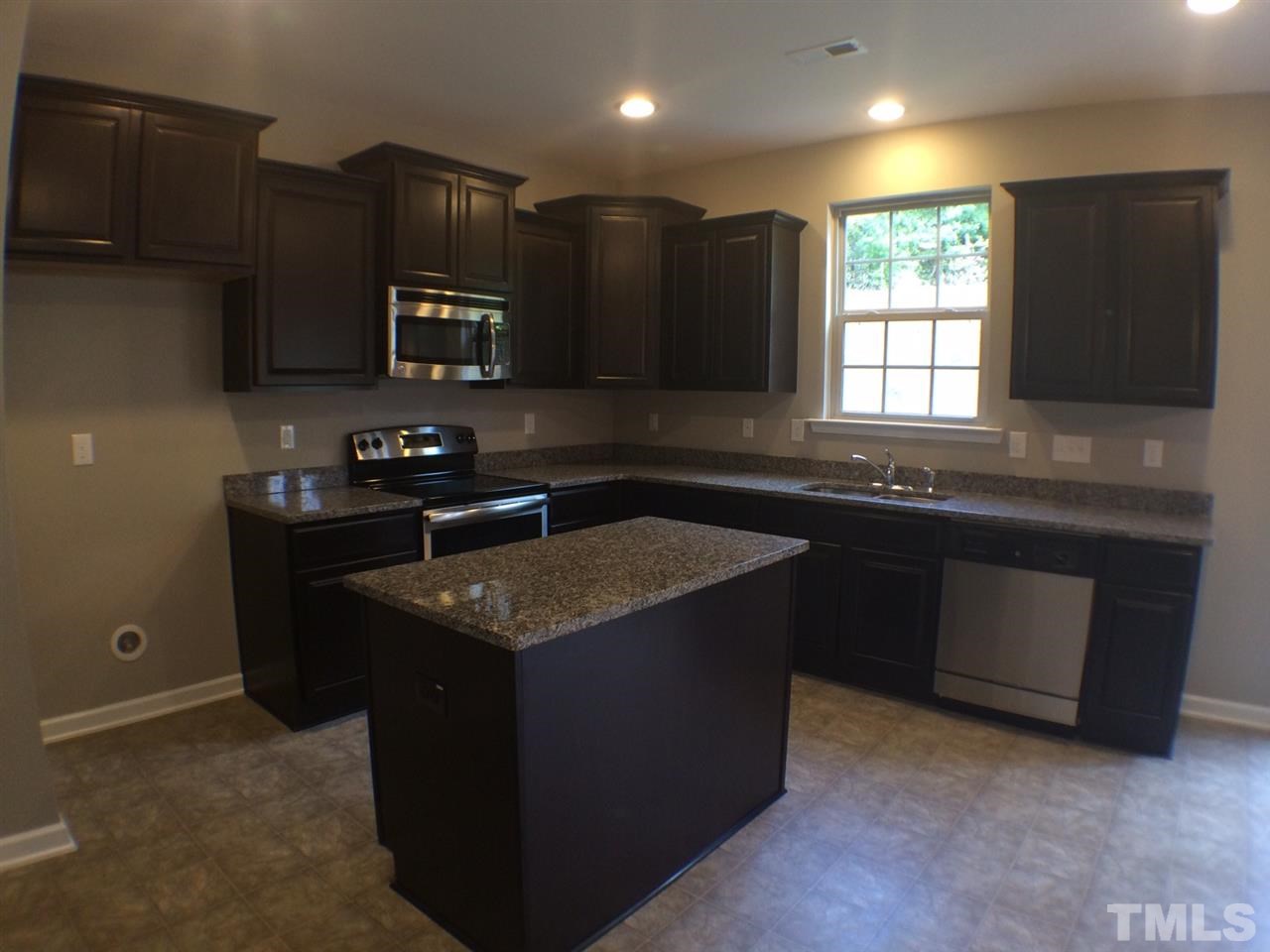 2712 Shepherd Valley Street Raleigh, NC 27610 - Photo 8 of 21 a kitchen with a sink stove and microwave