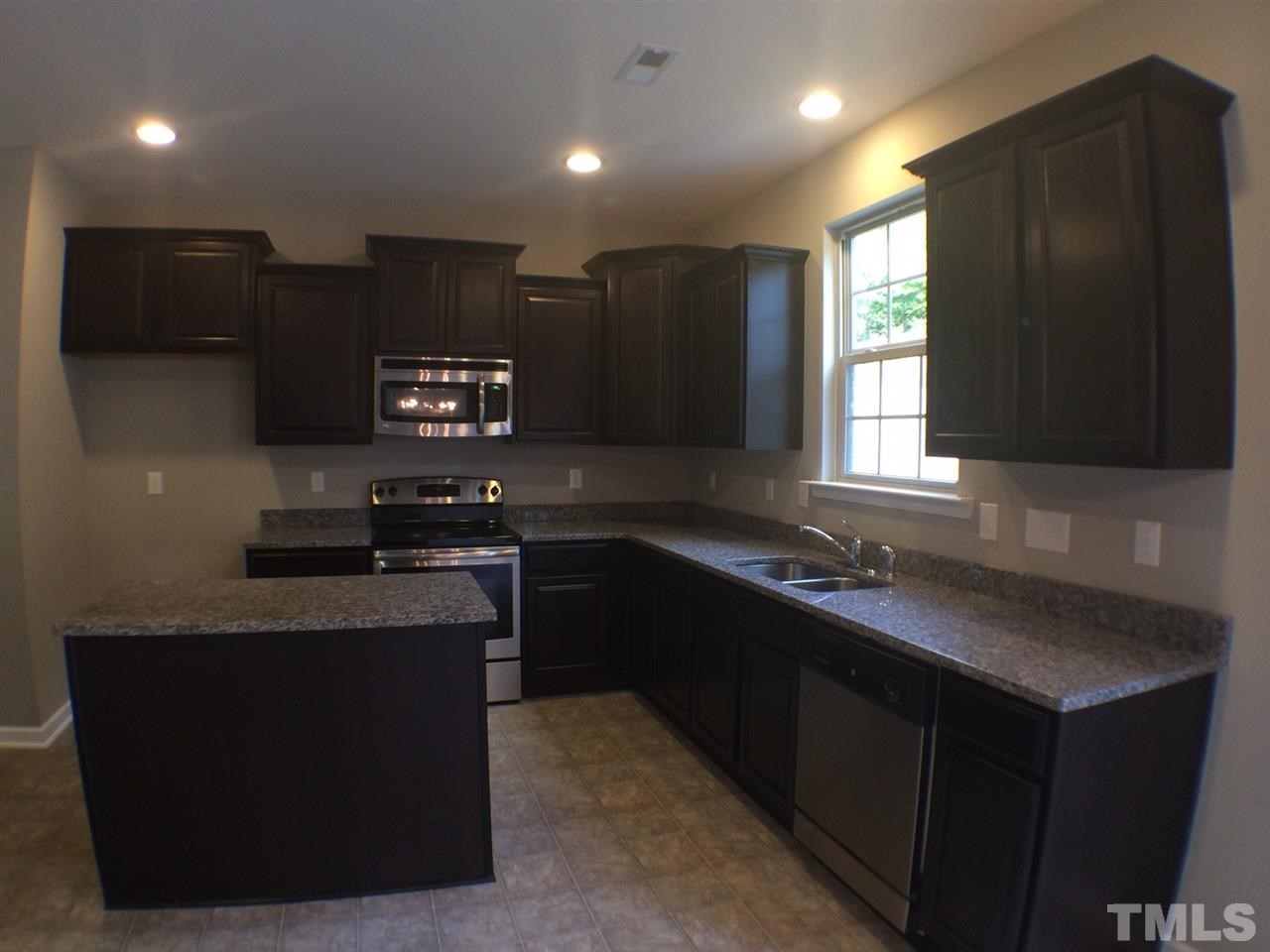 2712 Shepherd Valley Street Raleigh, NC 27610 - Photo 9 of 21 a kitchen with stainless steel appliances granite countertop a sink a stove a refrigerator a sink and a oven