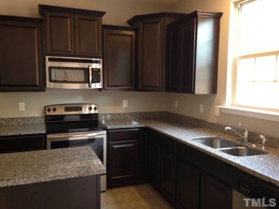 2712 Shepherd Valley Street Raleigh, NC 27610 - Photo 10 of 21 a kitchen with granite countertop stainless steel appliances and cabinets