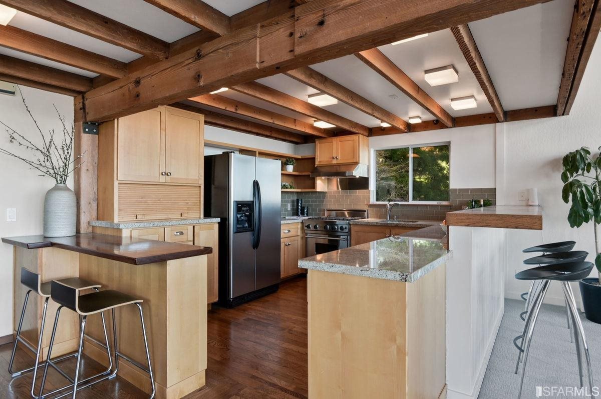 1502 Shotwell Street San Francisco, CA 94110 - Photo 18 of 61 a kitchen with stainless steel appliances granite countertop a sink a stove and a refrigerator