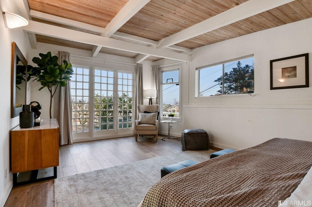 1502 Shotwell Street San Francisco, CA 94110 - Photo 21 of 61 a bedroom with a bed a couch and a large window