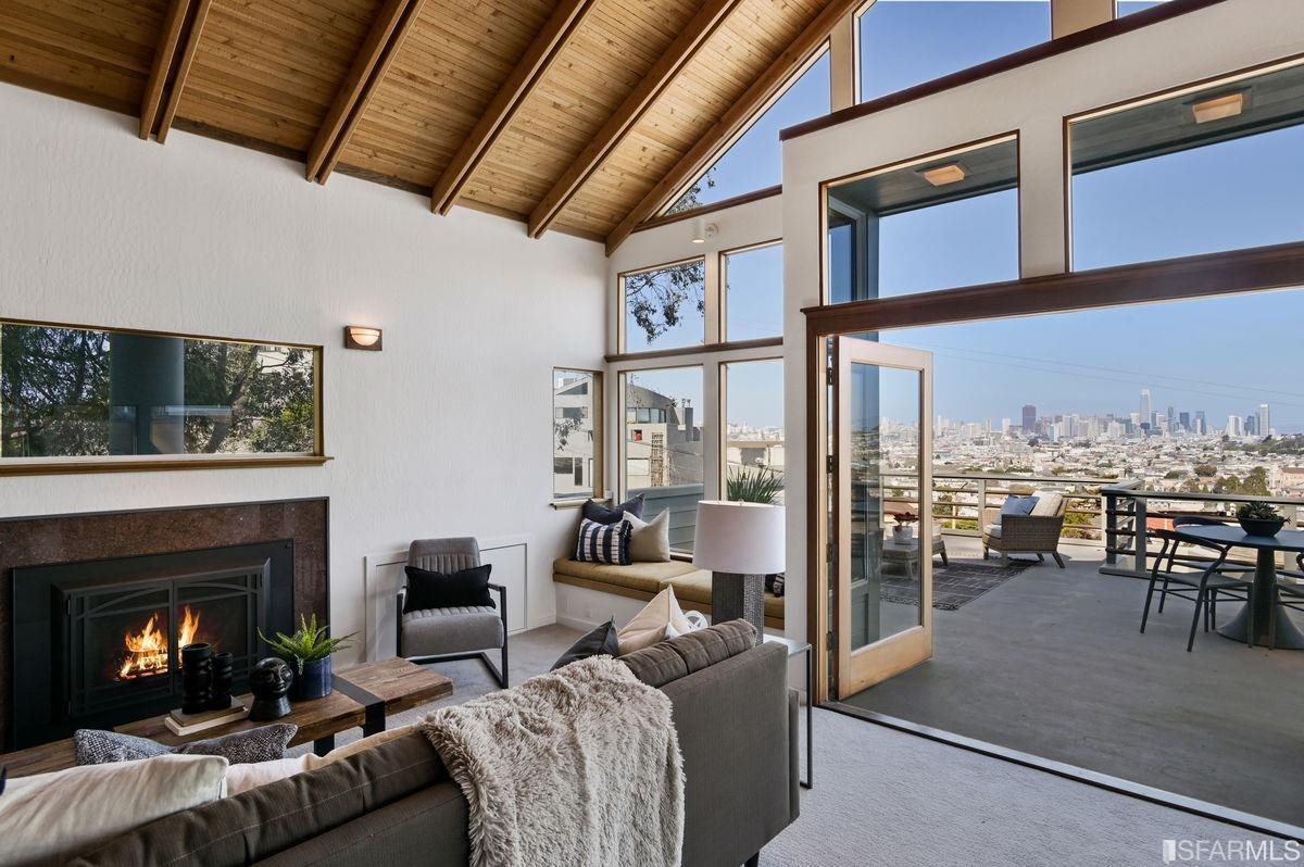1502 Shotwell Street San Francisco, CA 94110 - Photo 10 of 61 a living room with furniture a fireplace and a floor to ceiling window