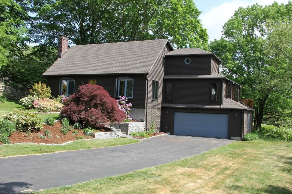 176 Kinney Road Hebron, CT 06231 - Photo 1 of 1 a front view of a house with a yard and garage
