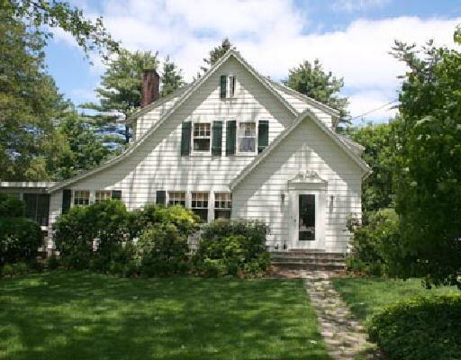 a front view of house with a garden