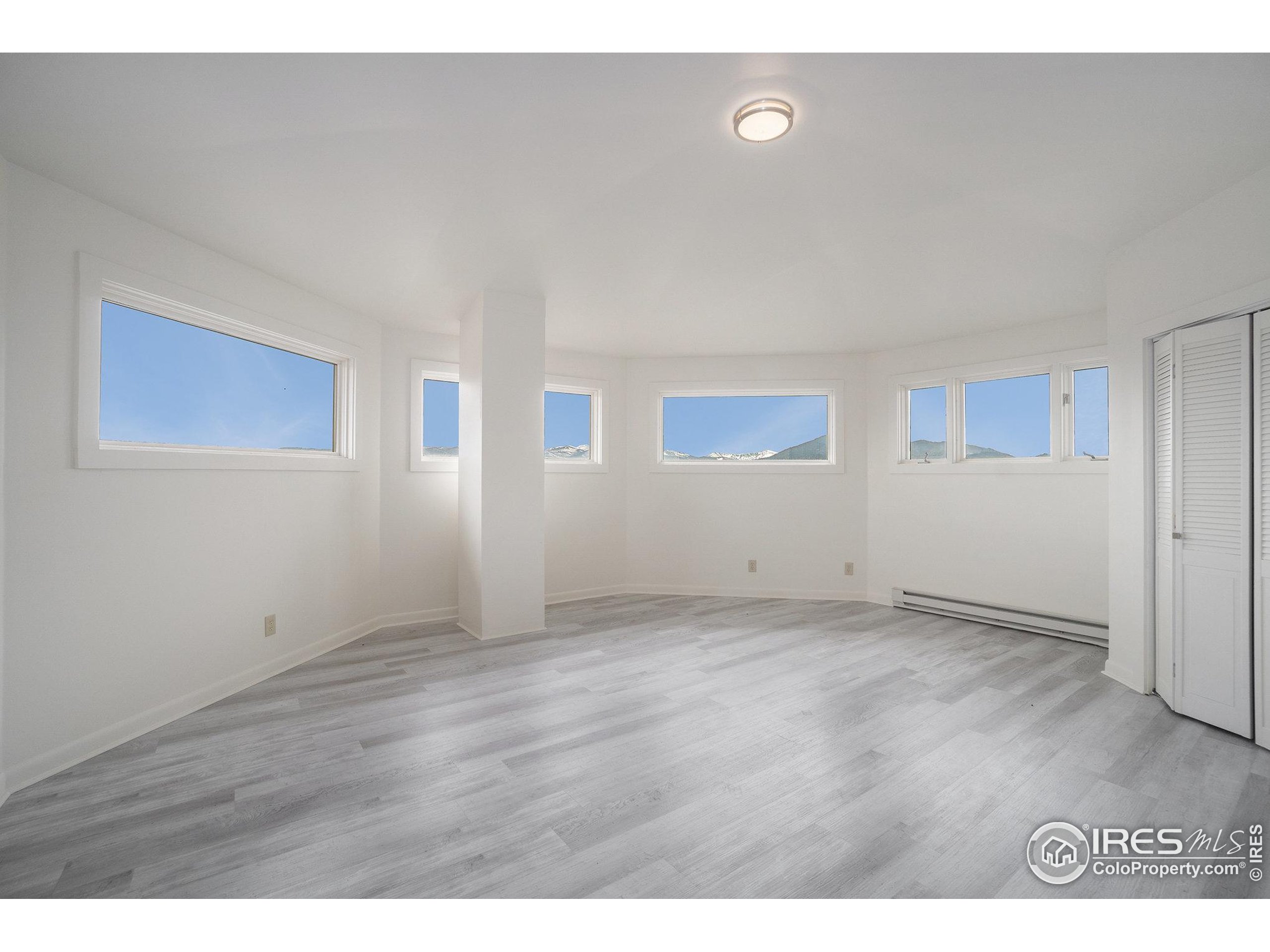 552 Blue Grouse Lane Bellvue, CO 80512 - Photo 14 of 39 a view of an empty room with wooden floor