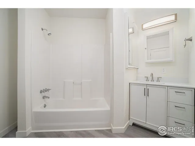 a bathroom with a bathtub and a sink