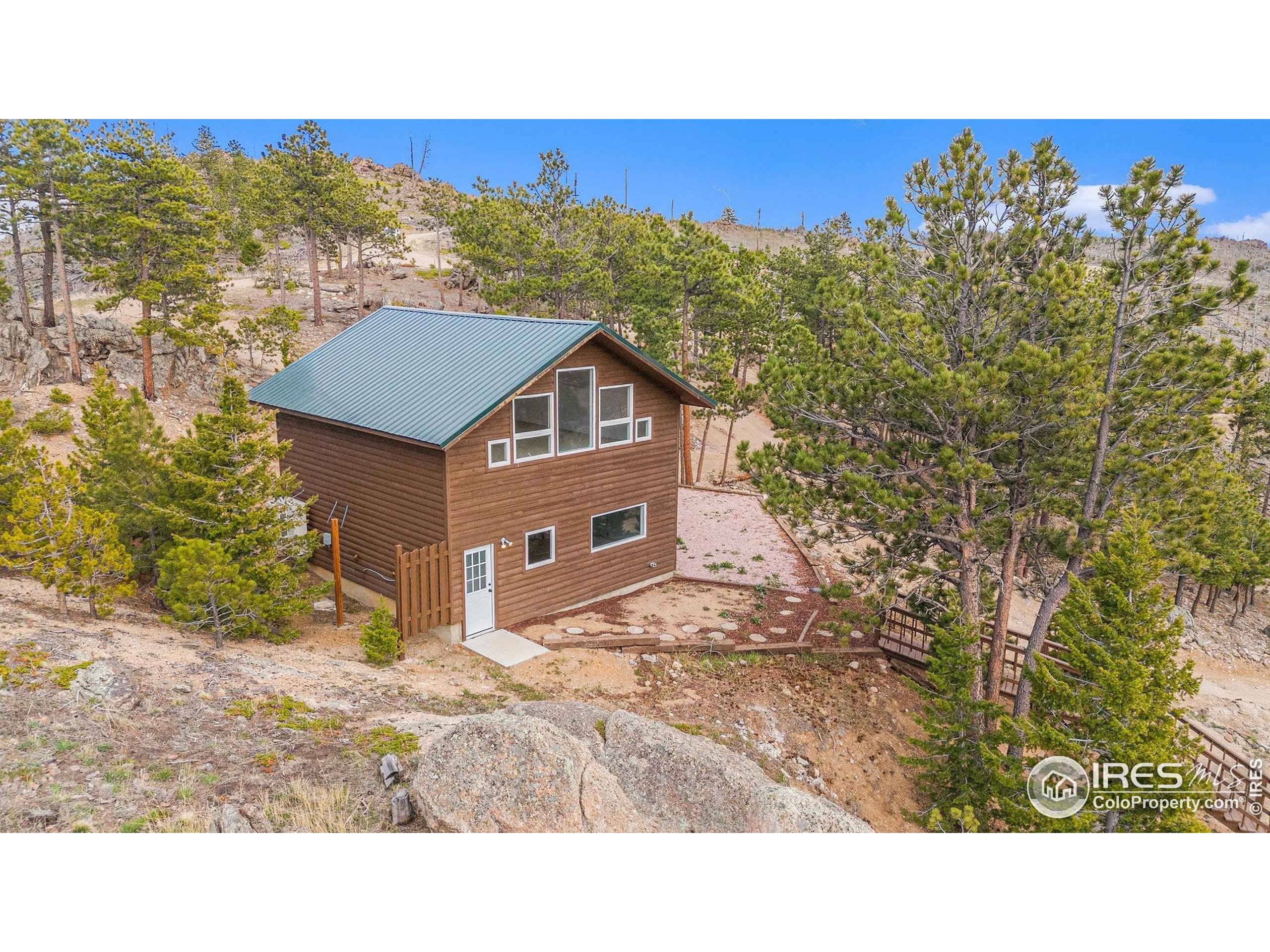 552 Blue Grouse Lane Bellvue, CO 80512 - Photo 33 of 39 a view of a house with a yard