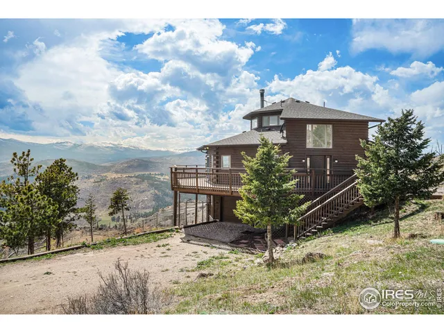 a view of a yard in front of a house with a large tree