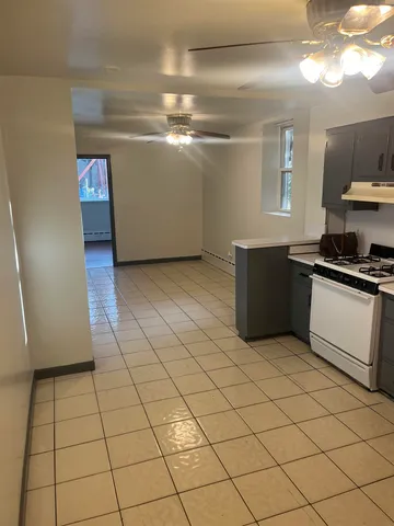 a kitchen with cabinets and steel appliances