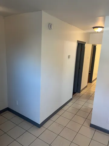 a view of a hallway to rooms