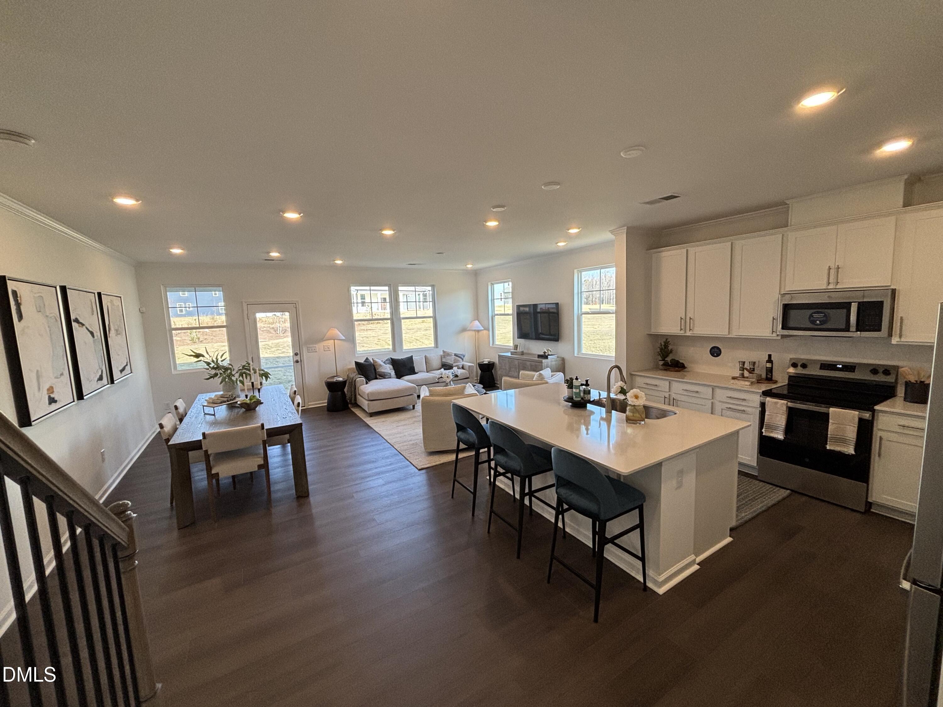 120 Blossom Fld Way Angier, NC 27501 - Photo 4 of 45 a kitchen with counter space dining table and chairs