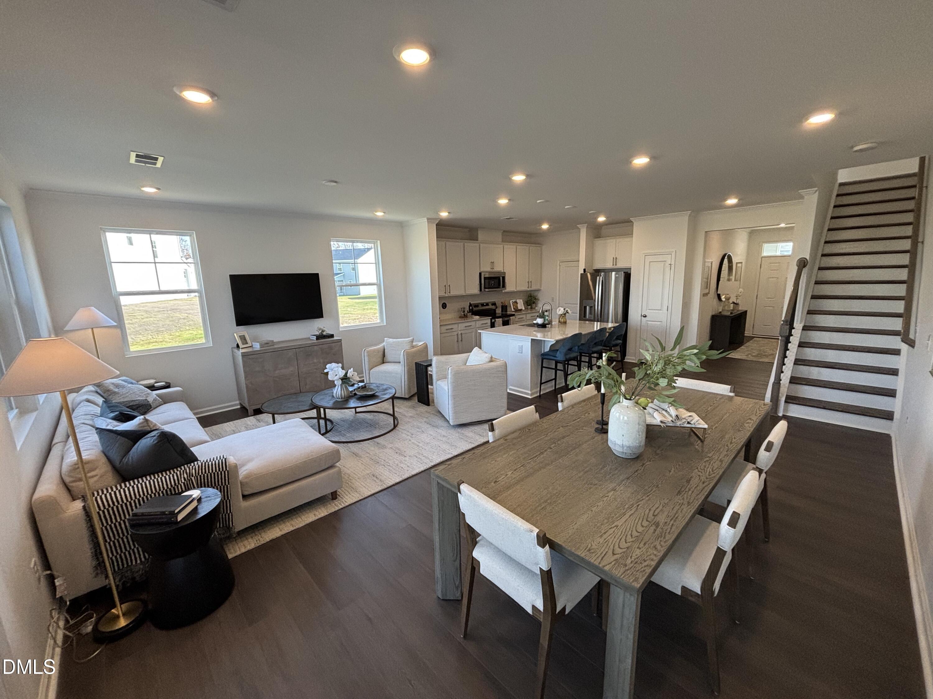 120 Blossom Fld Way Angier, NC 27501 - Photo 8 of 45 a living room with furniture kitchen view and a wooden floor