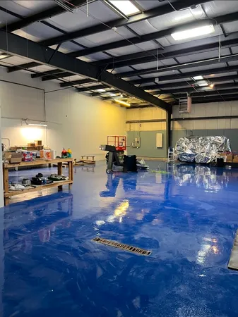 a living room with lots of furniture and a kitchen view
