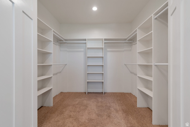 1820 West Farmhouse Flats Road Peoa, UT 84061 - Photo 26 of 79 Walk-in closet featuring built-in shelving, hanging rods, carpet flooring, and a recessed ceiling light