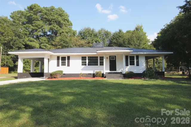 a front view of a house with a garden and porch