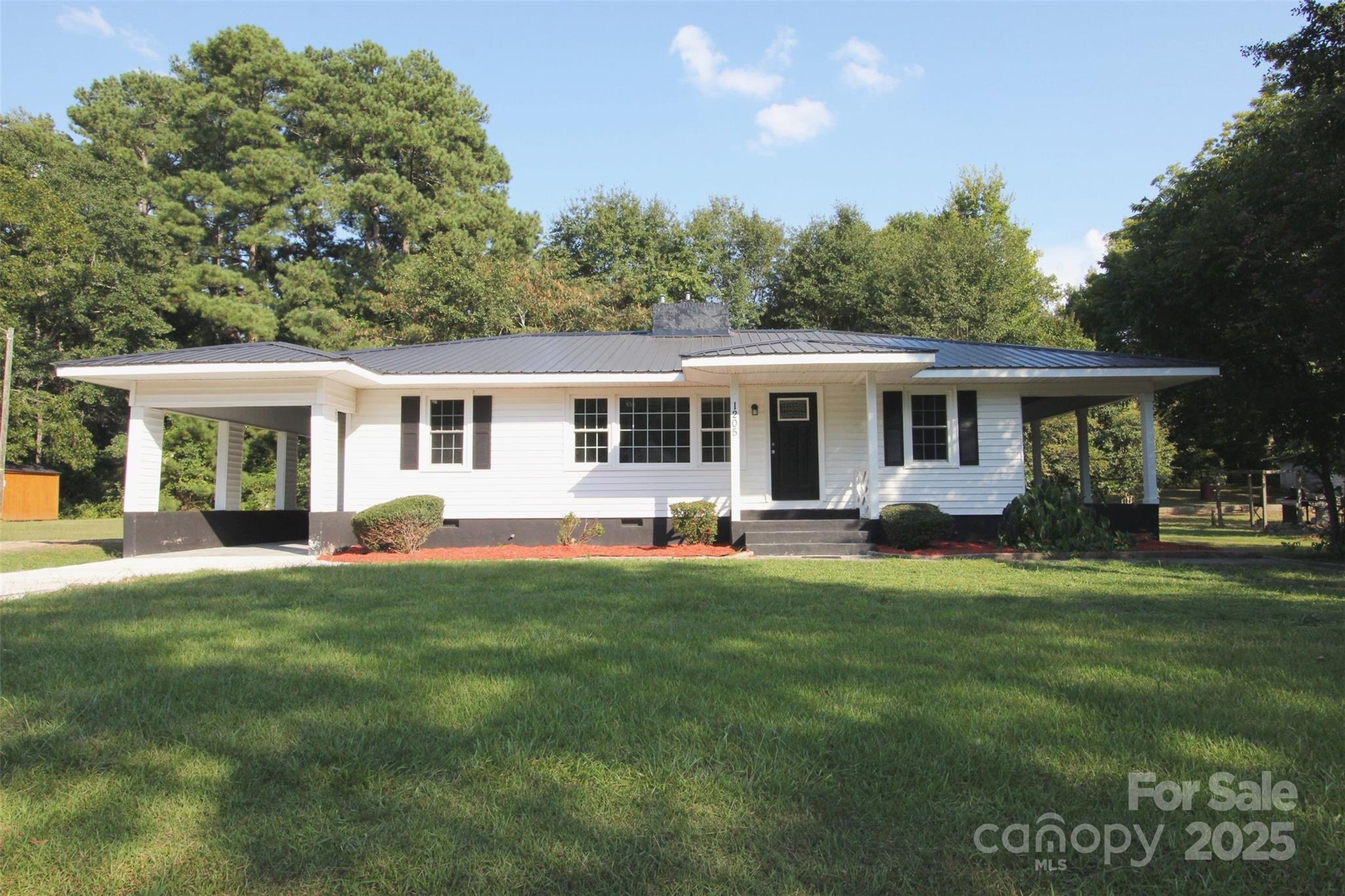 a front view of a house with a garden and porch