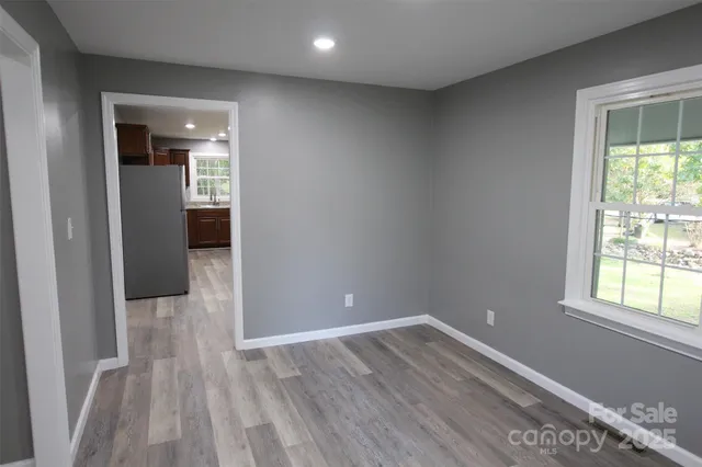 a view of a room with wooden floor and a window