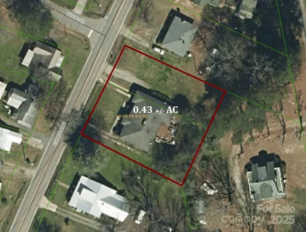 an aerial view of a residential houses with yard