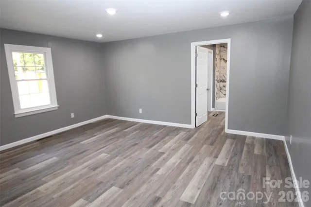 a view of house with yard and trees in the background