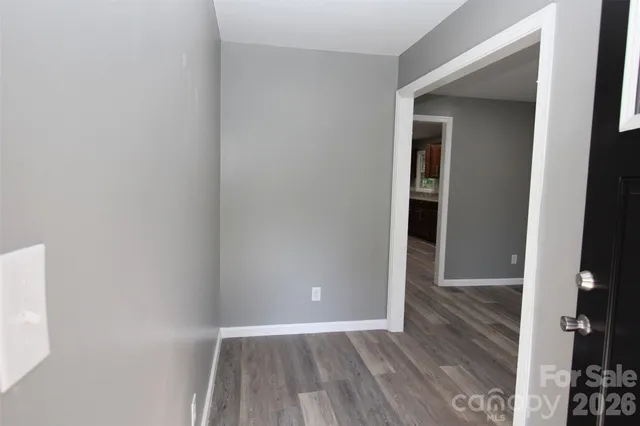 a view of an empty room and wooden floor
