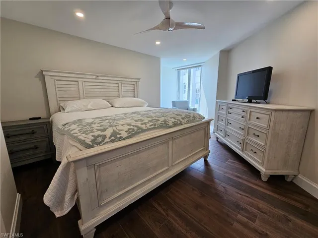 a bedroom with a bed and flat screen tv