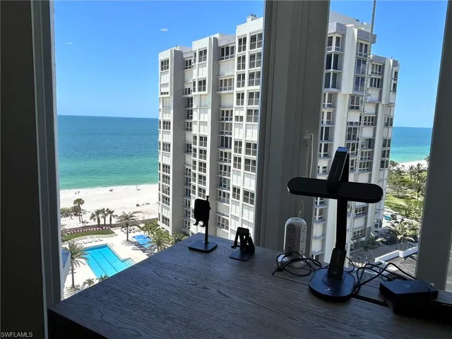 a dining room with furniture and a floor to ceiling window