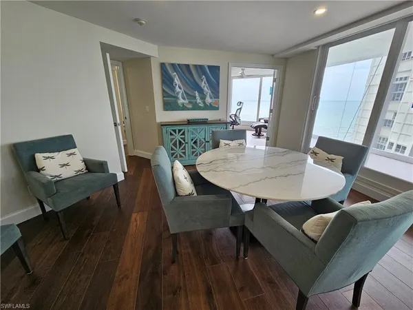 a view of a dining room with furniture and wooden floor