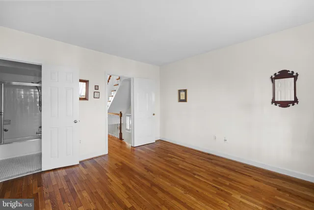 a bathroom with a granite countertop sink and shower