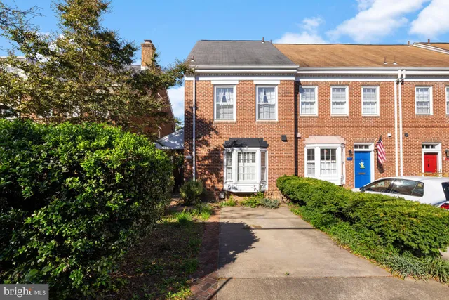 front view of a brick house with a yard