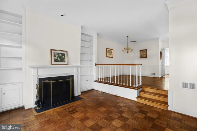 a view of a livingroom with a fireplace and staircase