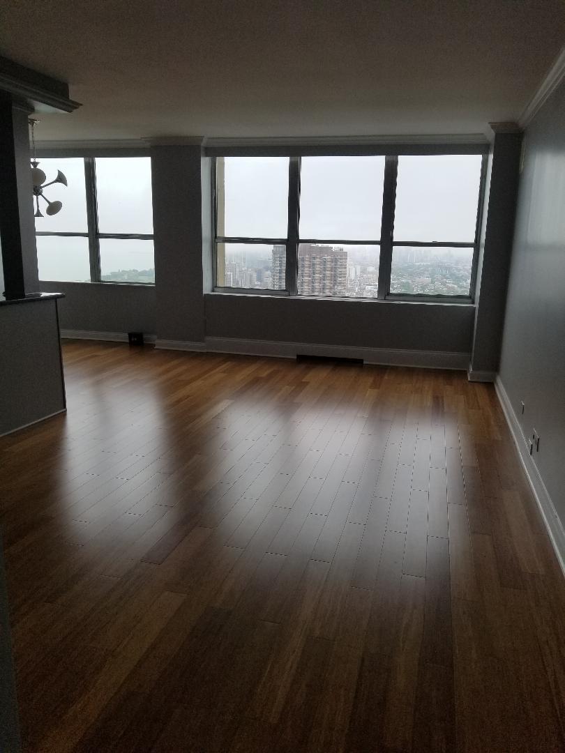 655 West Irving Park Road, Unit 5015 Chicago, IL 60613 - Photo 11 of 25 wooden floor in an empty room with a window