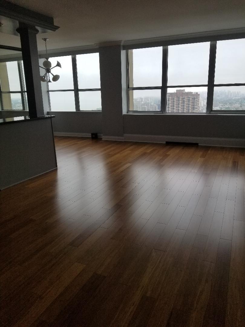 655 West Irving Park Road, Unit 5015 Chicago, IL 60613 - Photo 12 of 25 wooden floor in an empty room with a window